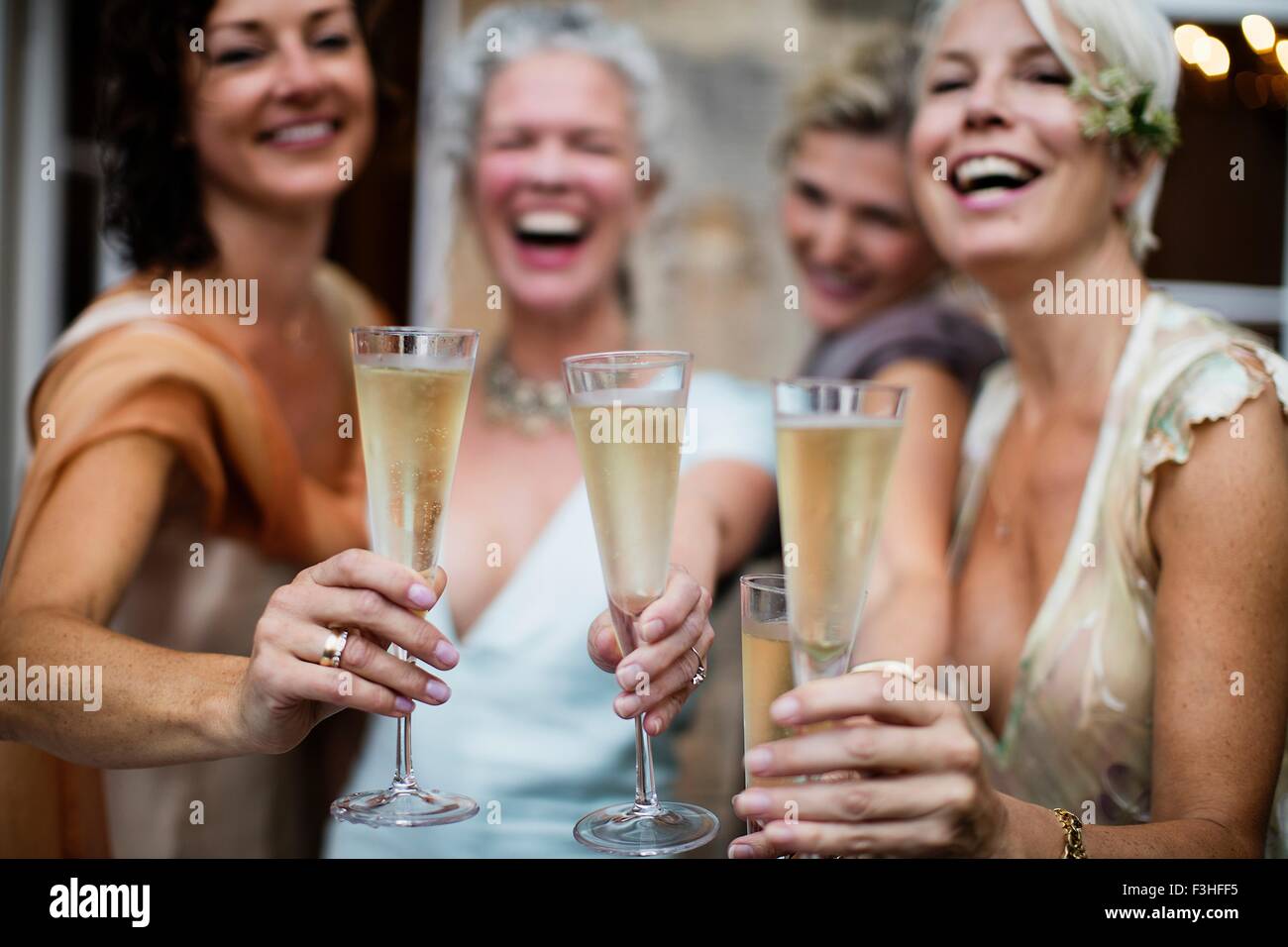 Elegant mature women toasting in urban garden Stock Photo