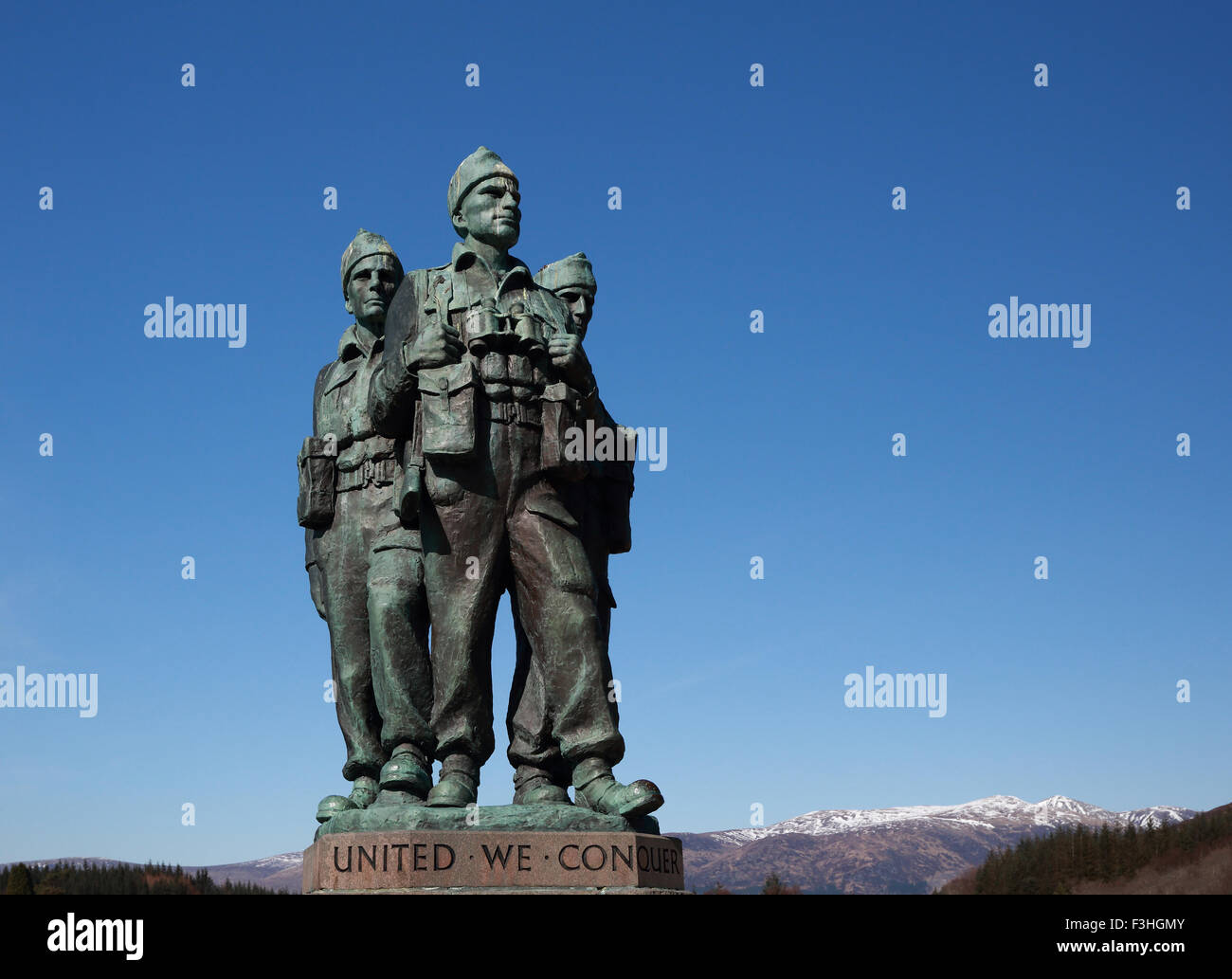 Commando Memorial against the blue sky and snow-capped mountains in the background Stock Photo
