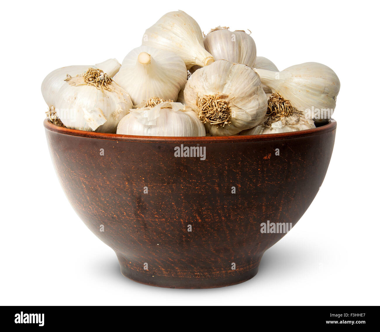 In front whole head of garlic in ceramic bowl isolated on white background Stock Photo