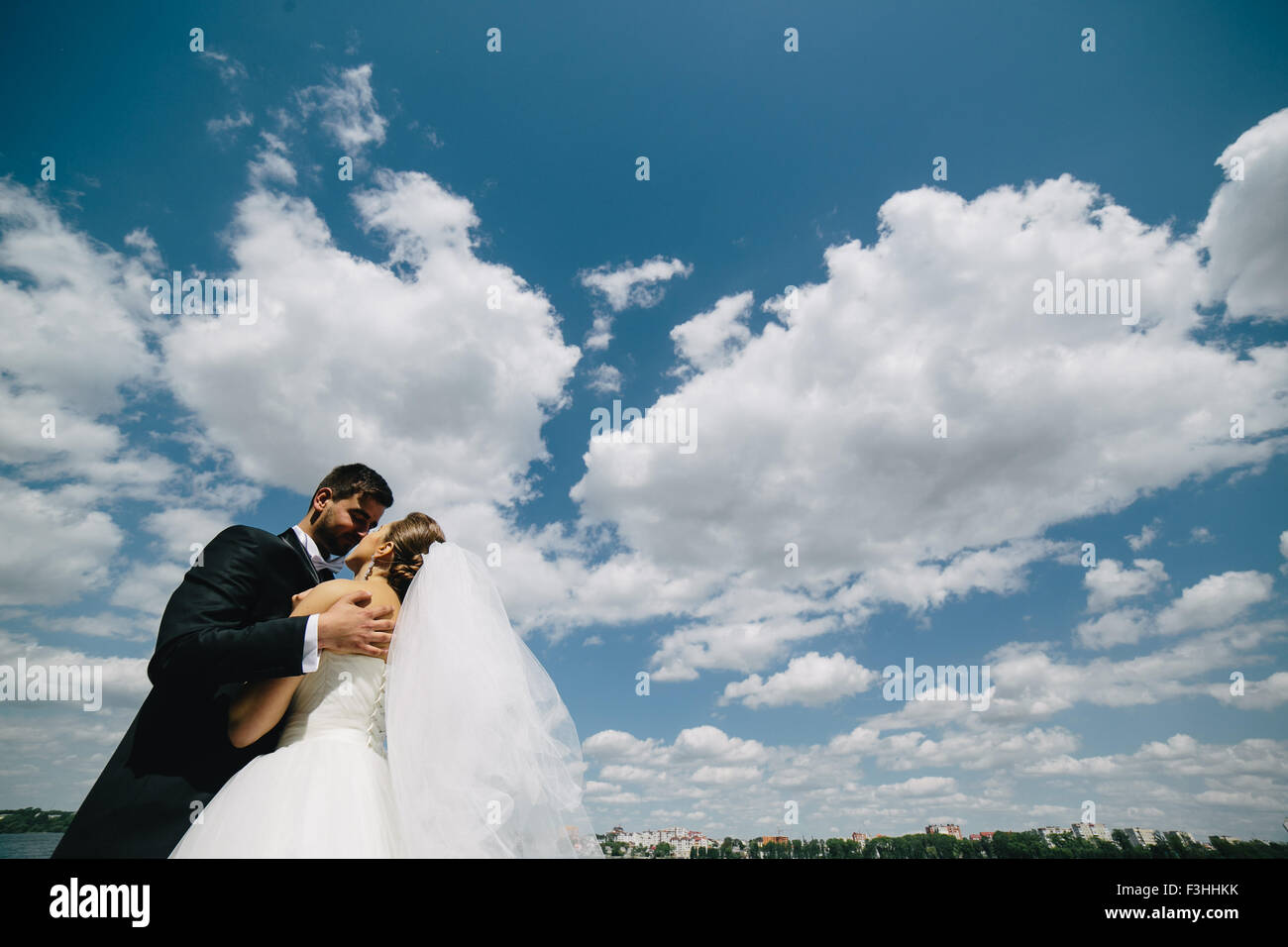 couple on blue sky background, water Stock Photo - Alamy
