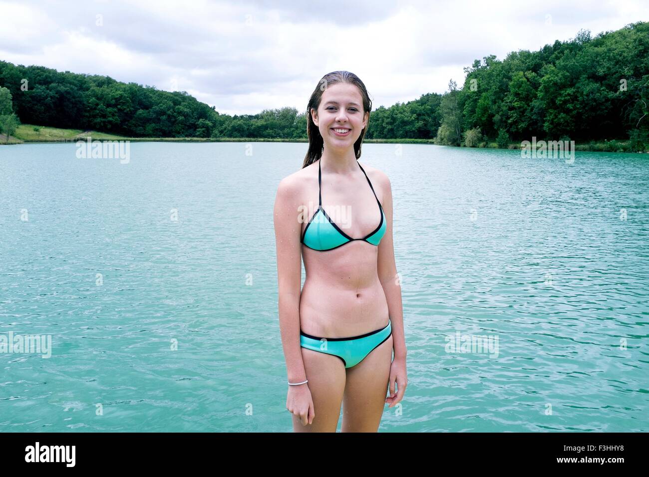 Portrait of teenage girl wearing bikini standing in front of lake, Tilac,  South West France Stock Photo - Alamy