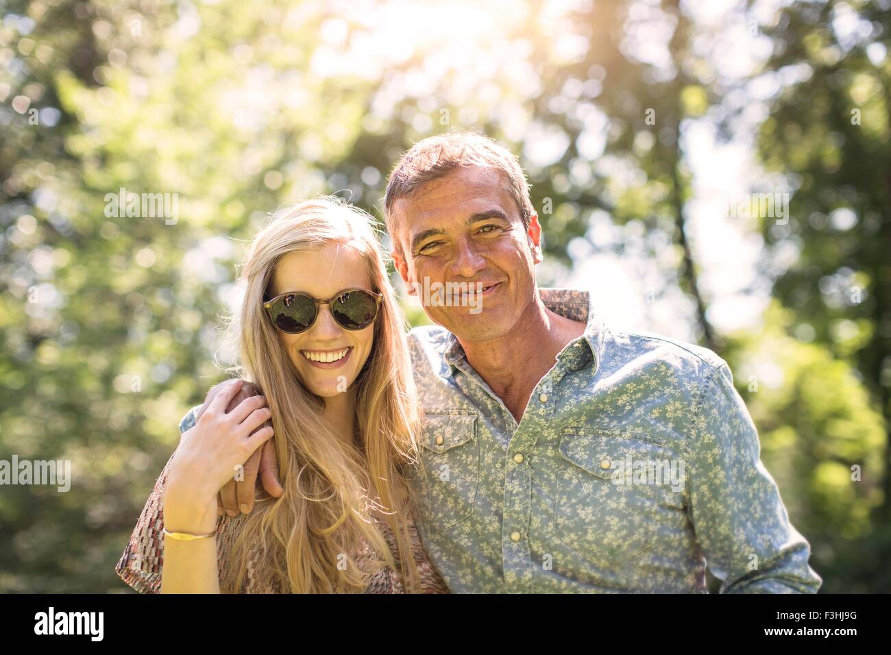 Portrait of mature man and girlfriend in garden Stock Photo