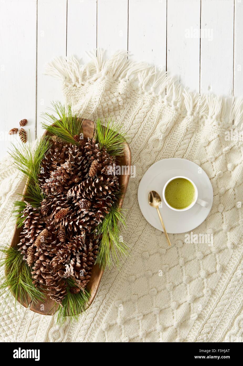 Still life with pine cones and needles and cup of matcha tea Stock Photo