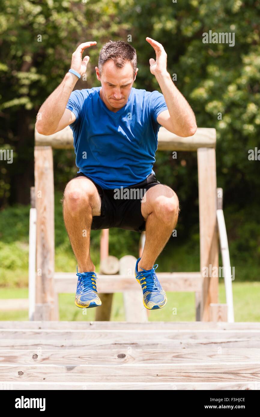 Mid adult man, working out, outdoors Stock Photo