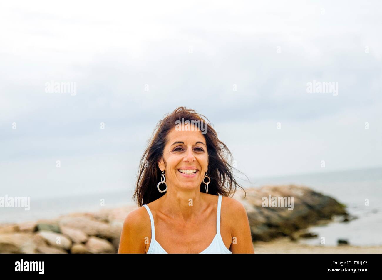 Portrait of smiling mature woman at coast, Stock Photo