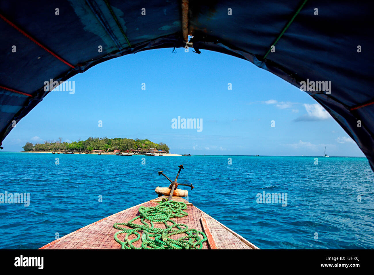 Wooden boat off the beach of Prison Island under blue sky, Zanzibar, Tanzania, Africa Stock Photo
