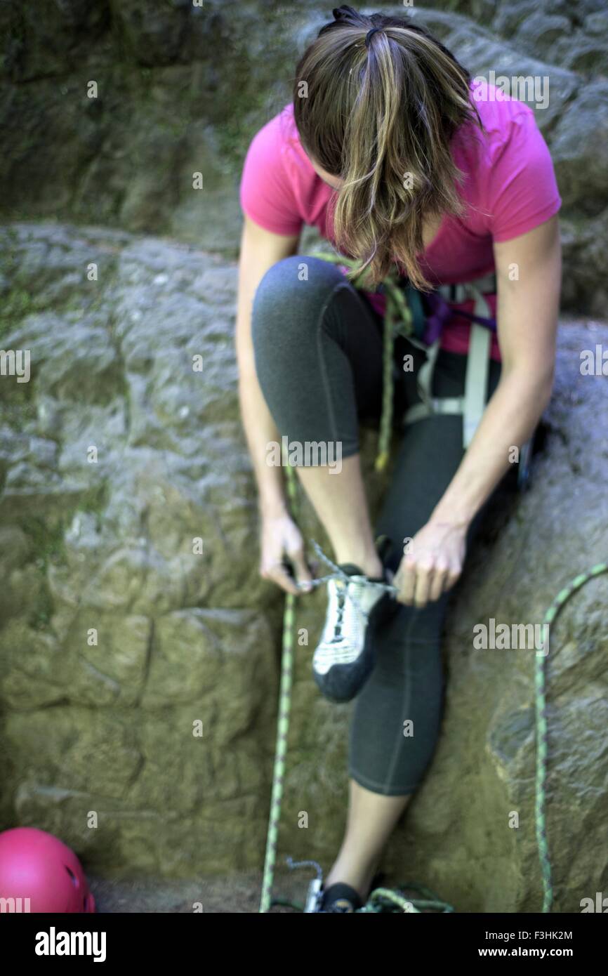 Rock climber tying shoelace, French's Dome, Zig Zag, Oregon, USA Stock Photo