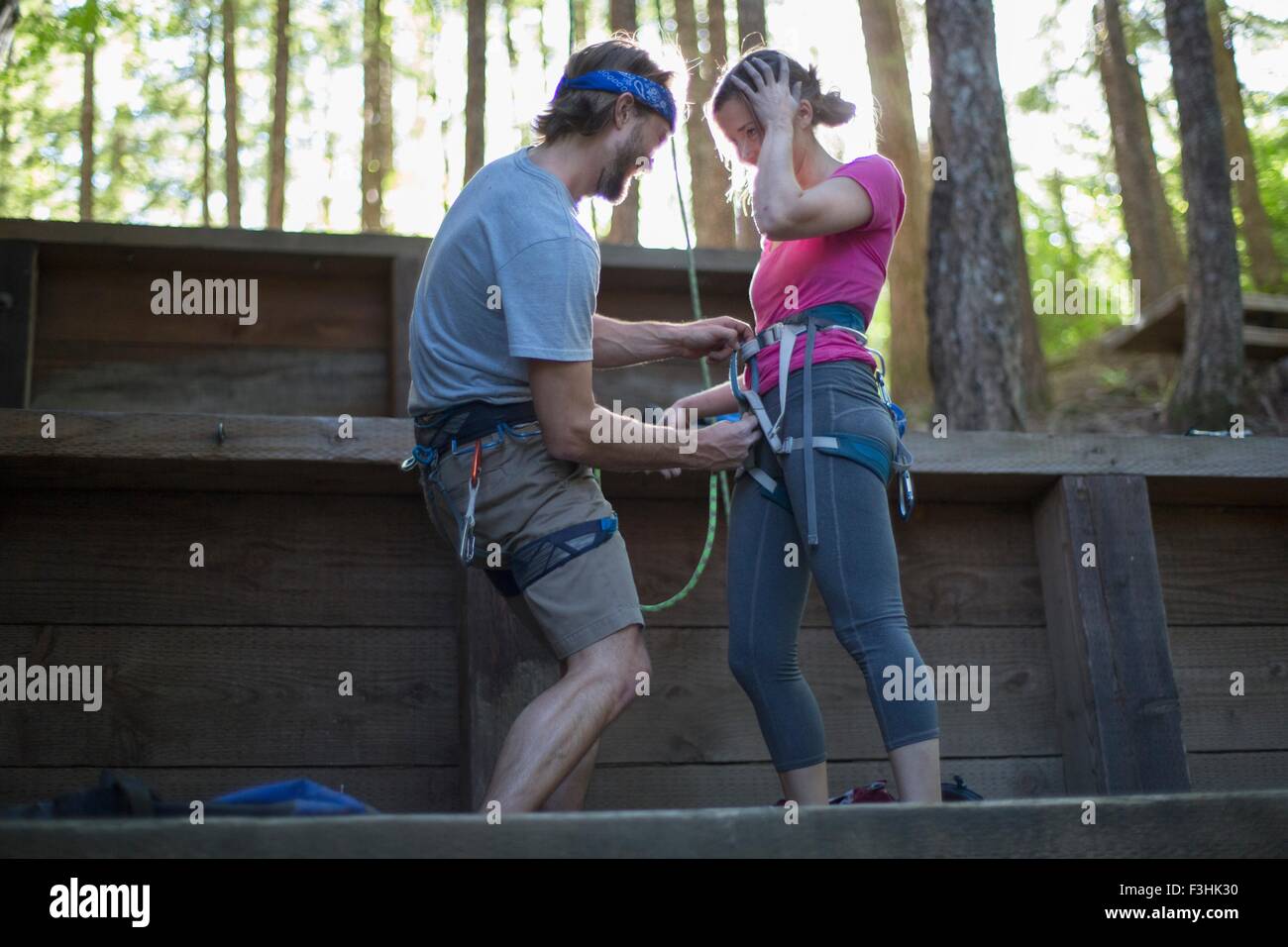 Couple preparing for rock climbing, French's Dome, Zig Zag, Oregon, USA