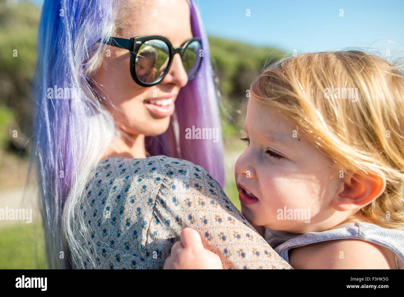 Mother and baby enjoying sun, El Capitan, California, USA Stock Photo