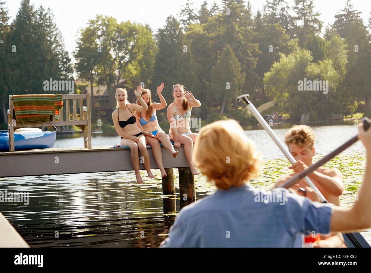 Friends rowing boat in lake, Seattle, Washington, USA Stock Photo