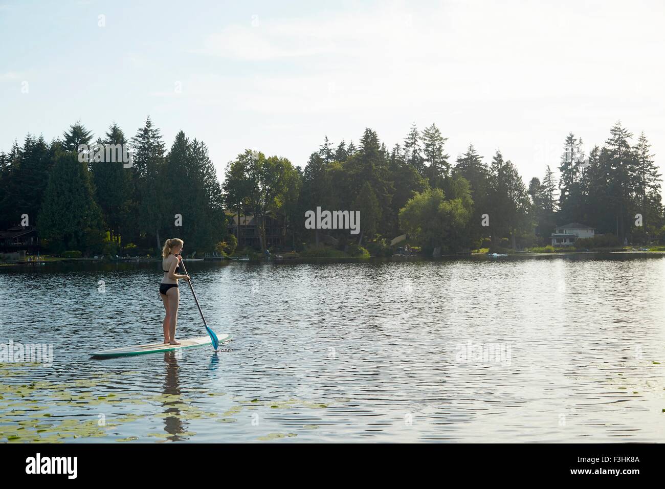 Girl paddling boat in lake, Seattle, Washington, USA Stock Photo