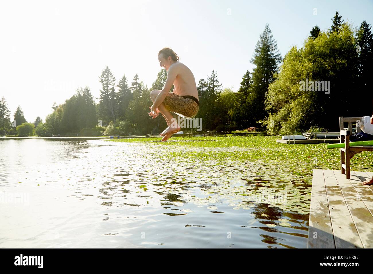 Man jumping into lake, Seattle, Washington, USA Stock Photo