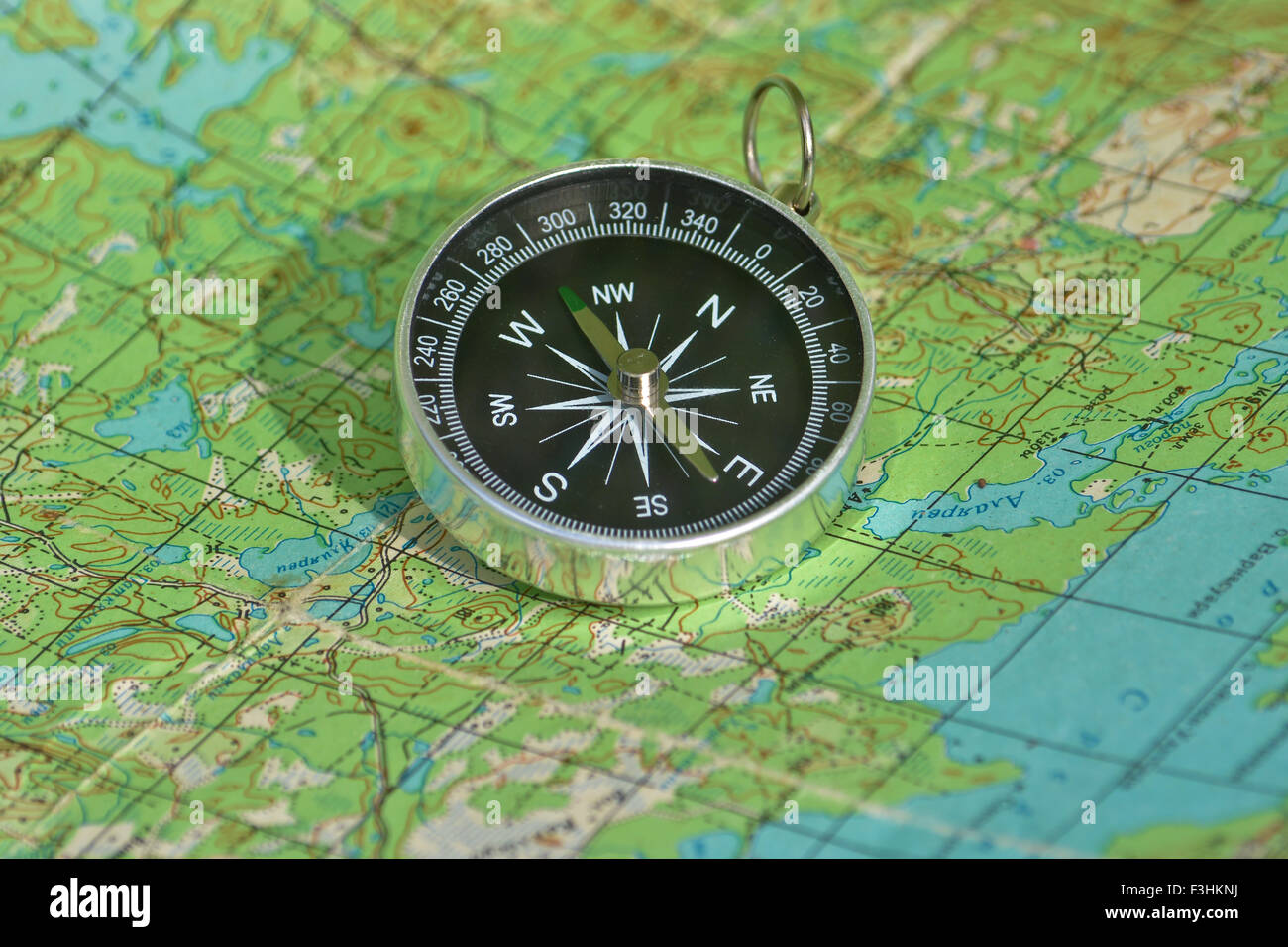 Magnetic compass is located on a topographic map. A map with a compass ...