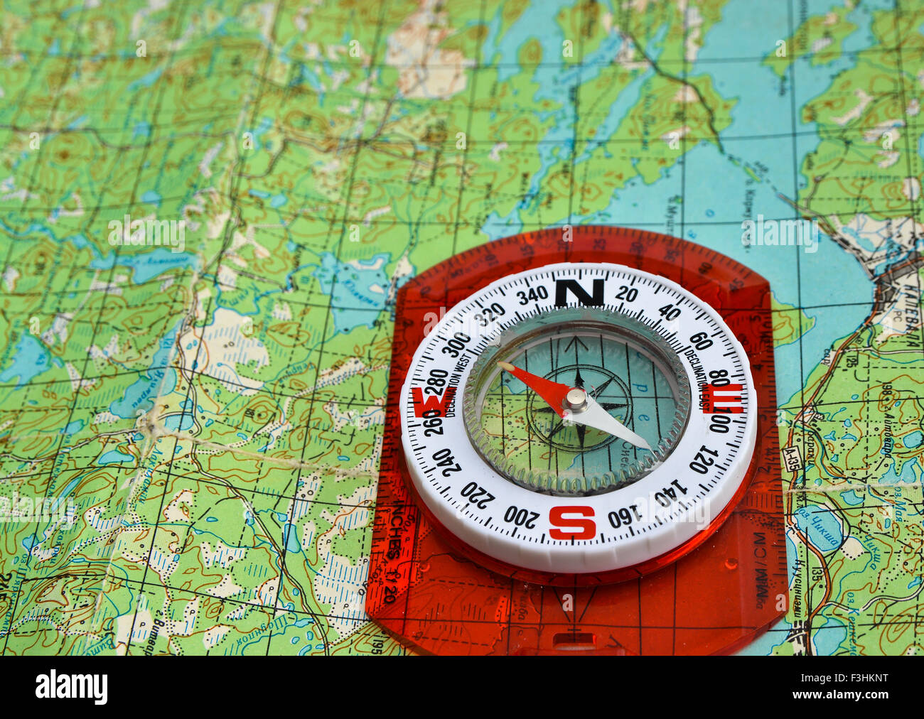 compass is located on a topographic map. Orienteering in the