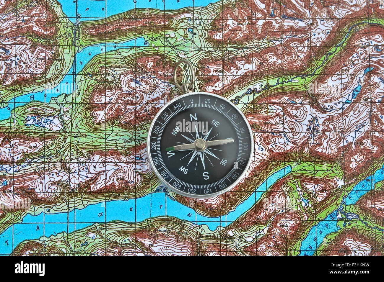 compass is located on a topographic map. Orienteering in the