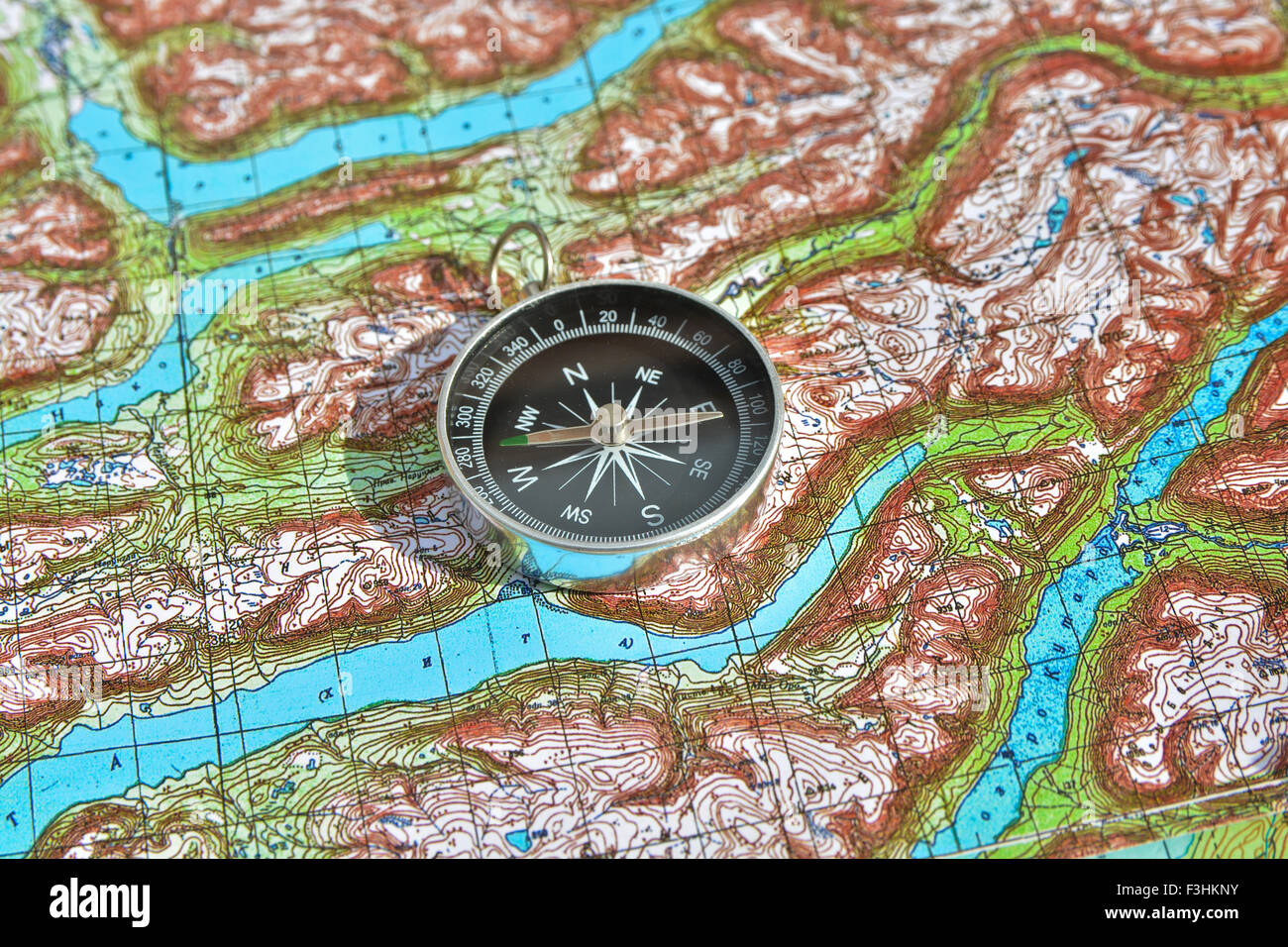 compass is located on a topographic map. Orienteering in the