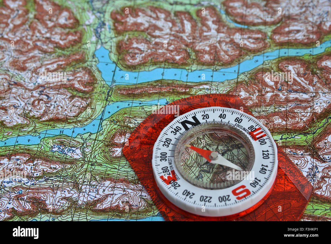 compass is located on a topographic map. Orienteering in the