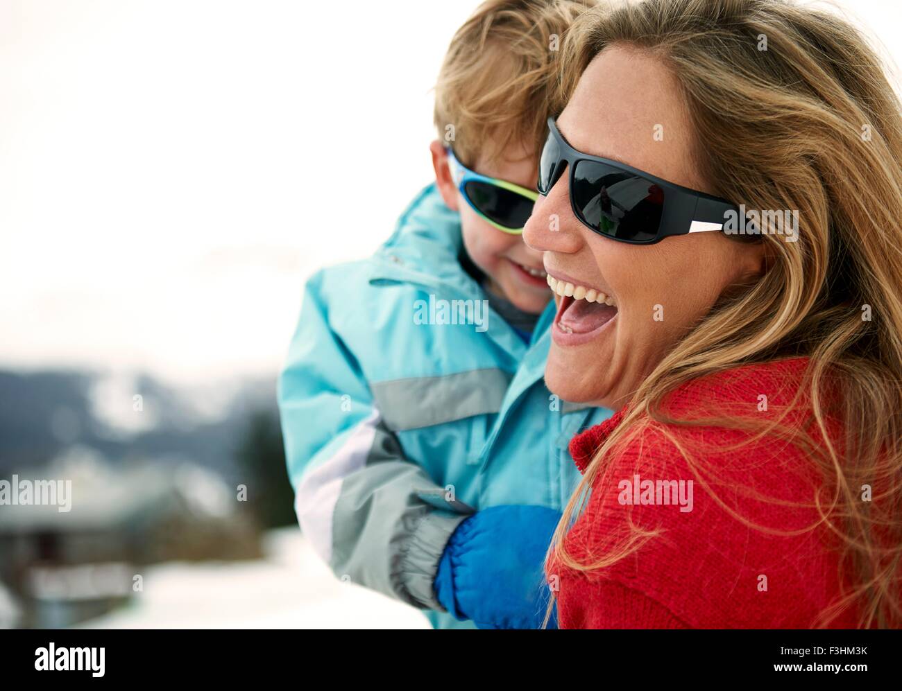 Skiing mother carrying toddler son Stock Photo