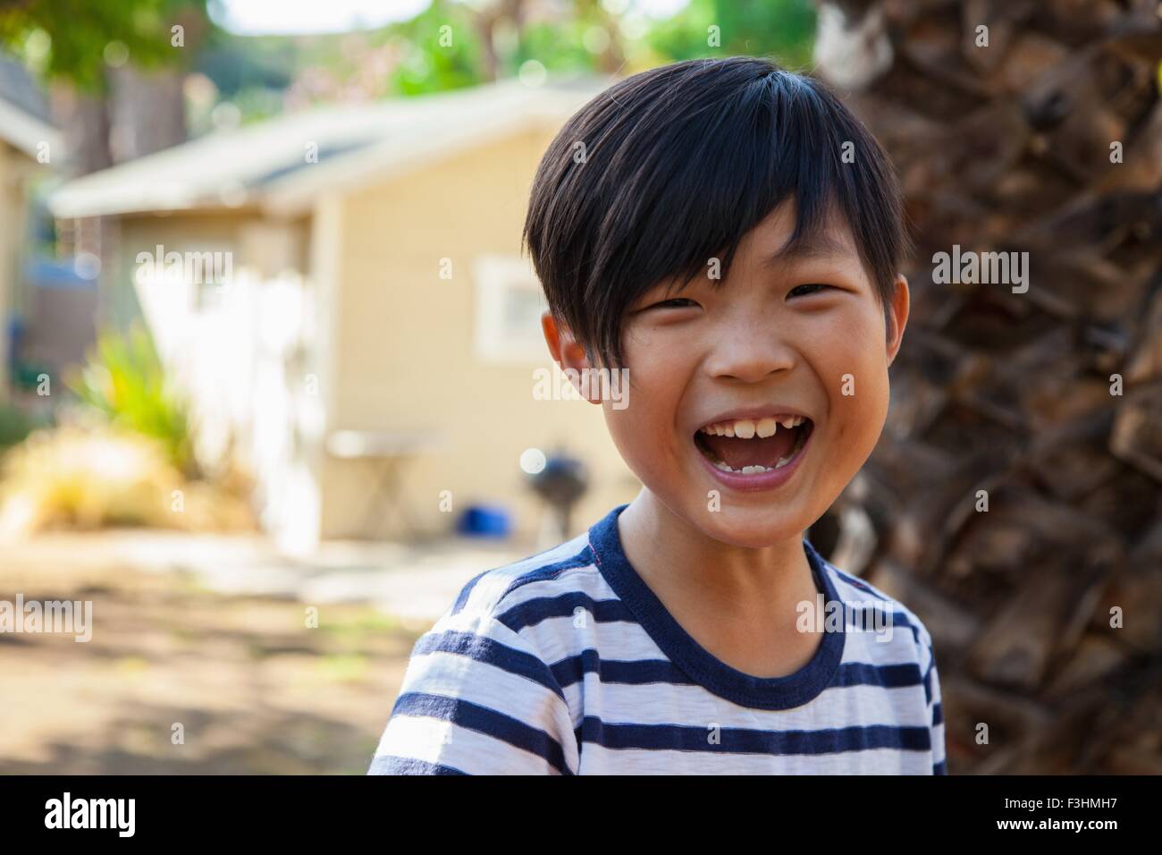 Portrait of cute happy boy in garden Stock Photo - Alamy