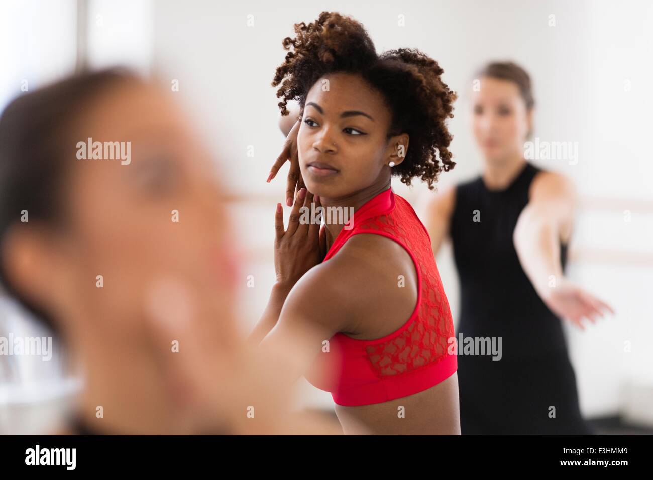Young women dancing looking away, differential focus Stock Photo