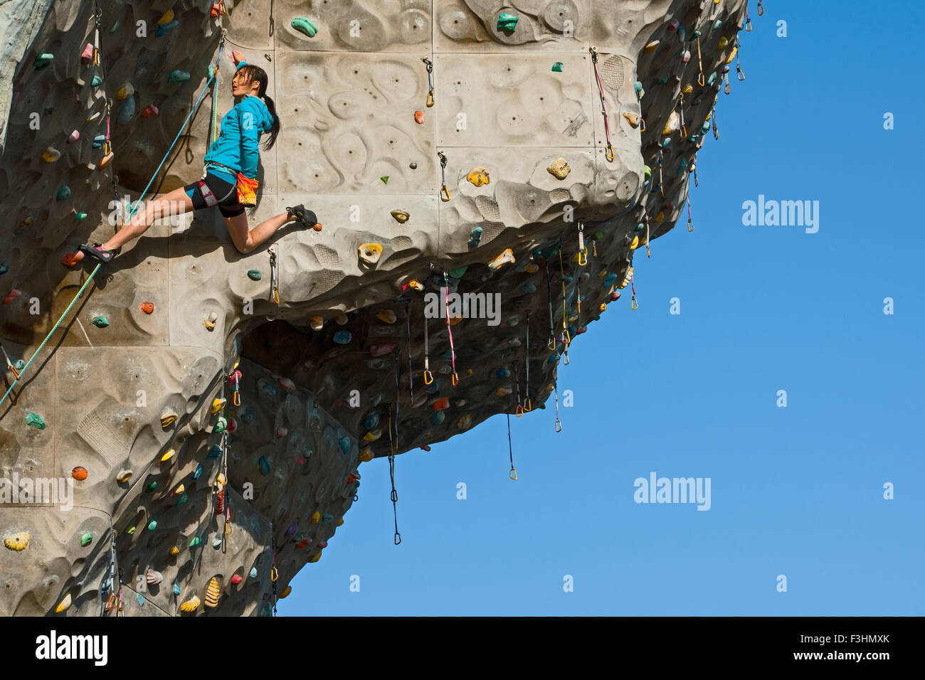 Woman climbing on artificial climbing wall in Seoul Stock Photo Alamy