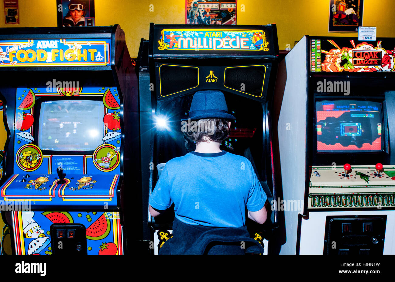 A boy plays video games in the American Classic Arcade Museum in Laconia, New Hampshire, USA. Stock Photo