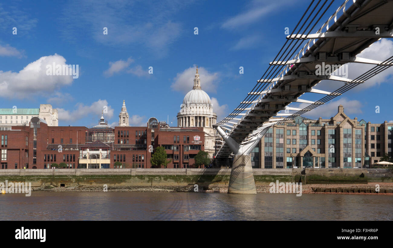 Millennium Bridge (Wobbly Bridge) and River Thames at low tide with St Paul's Cathedral at the focal point City of London UK Stock Photo