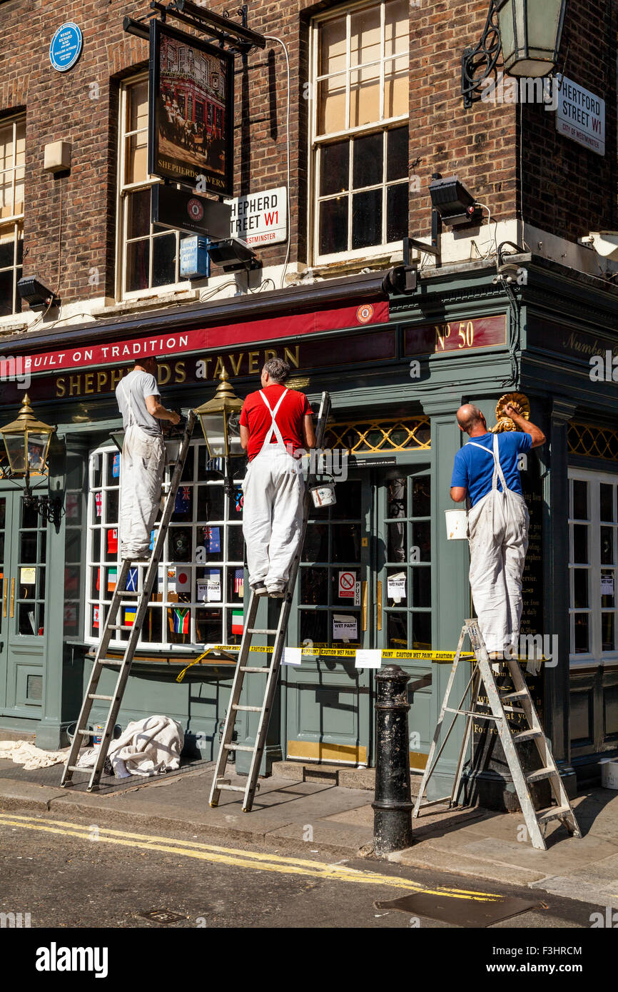 Painters and Decorators Painting A Pub Exterior, Shepherd Market, London,  UK Stock Photo - Alamy