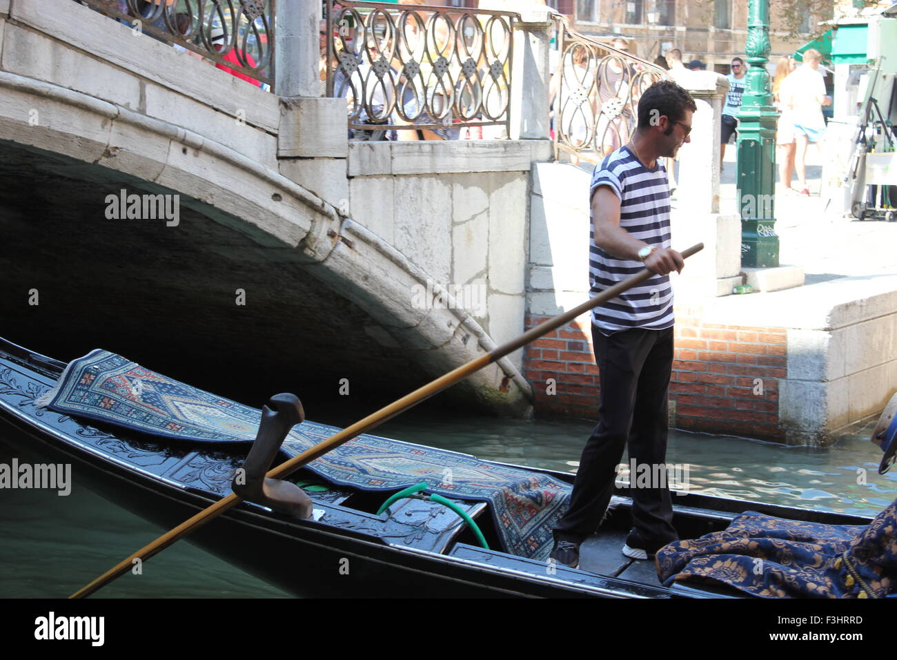 A gondolier at work in Venice, Italy Stock Photo