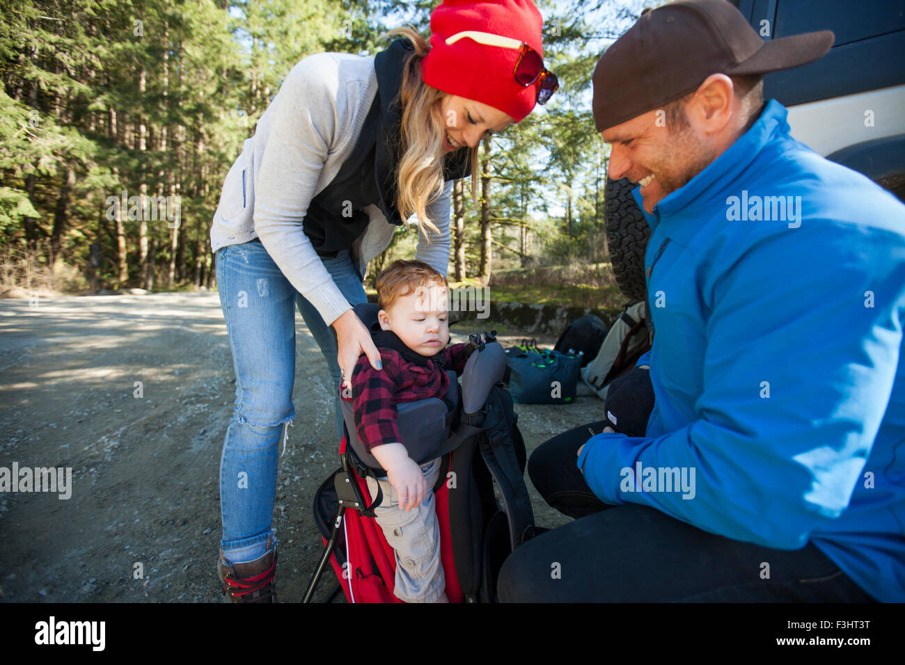 Young parents prepare for a backpacking trip with their child. Stock Photo