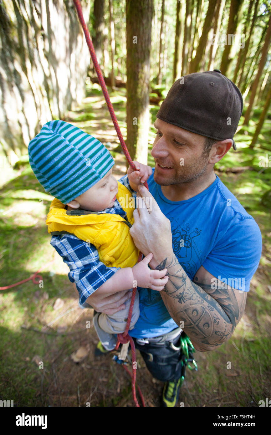 A rock climber holds his son. Stock Photo