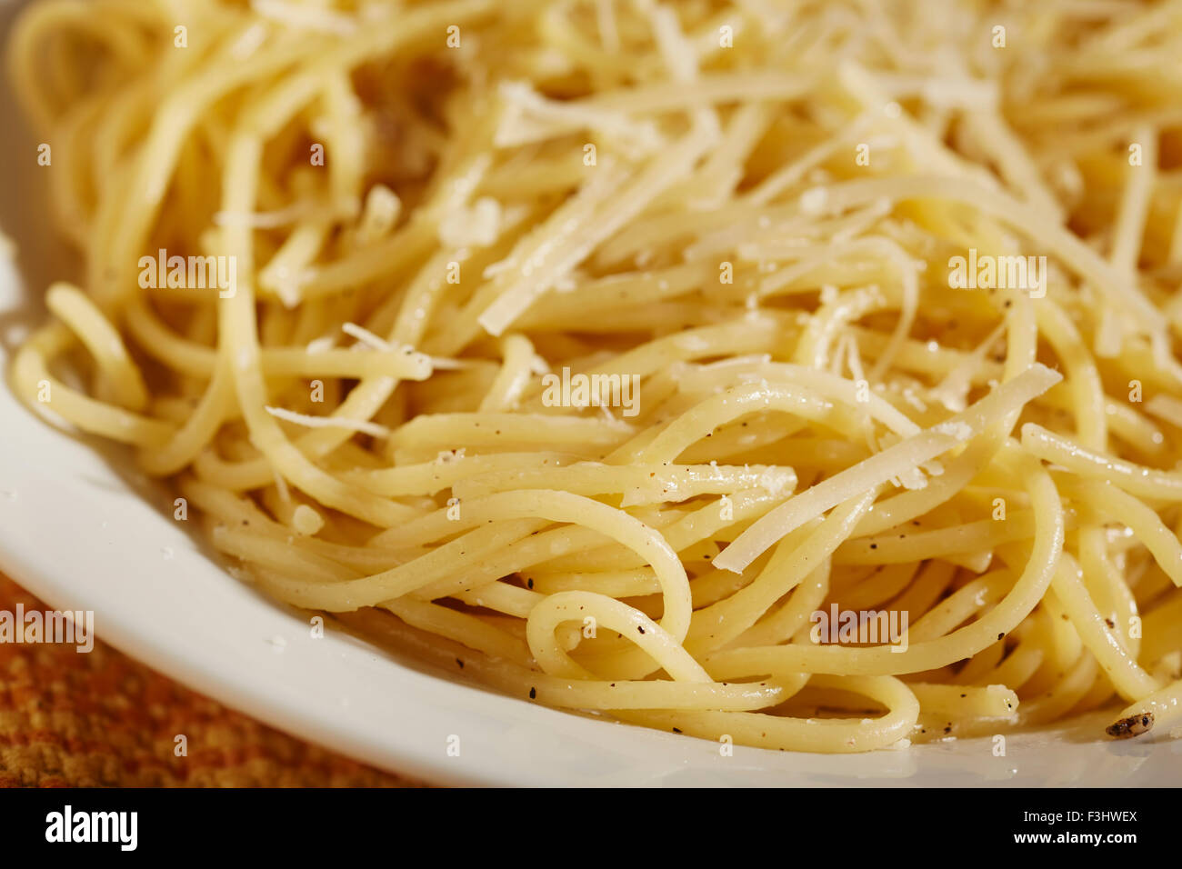 Cooked spaghetti with butter and shredded cheese Stock Photo