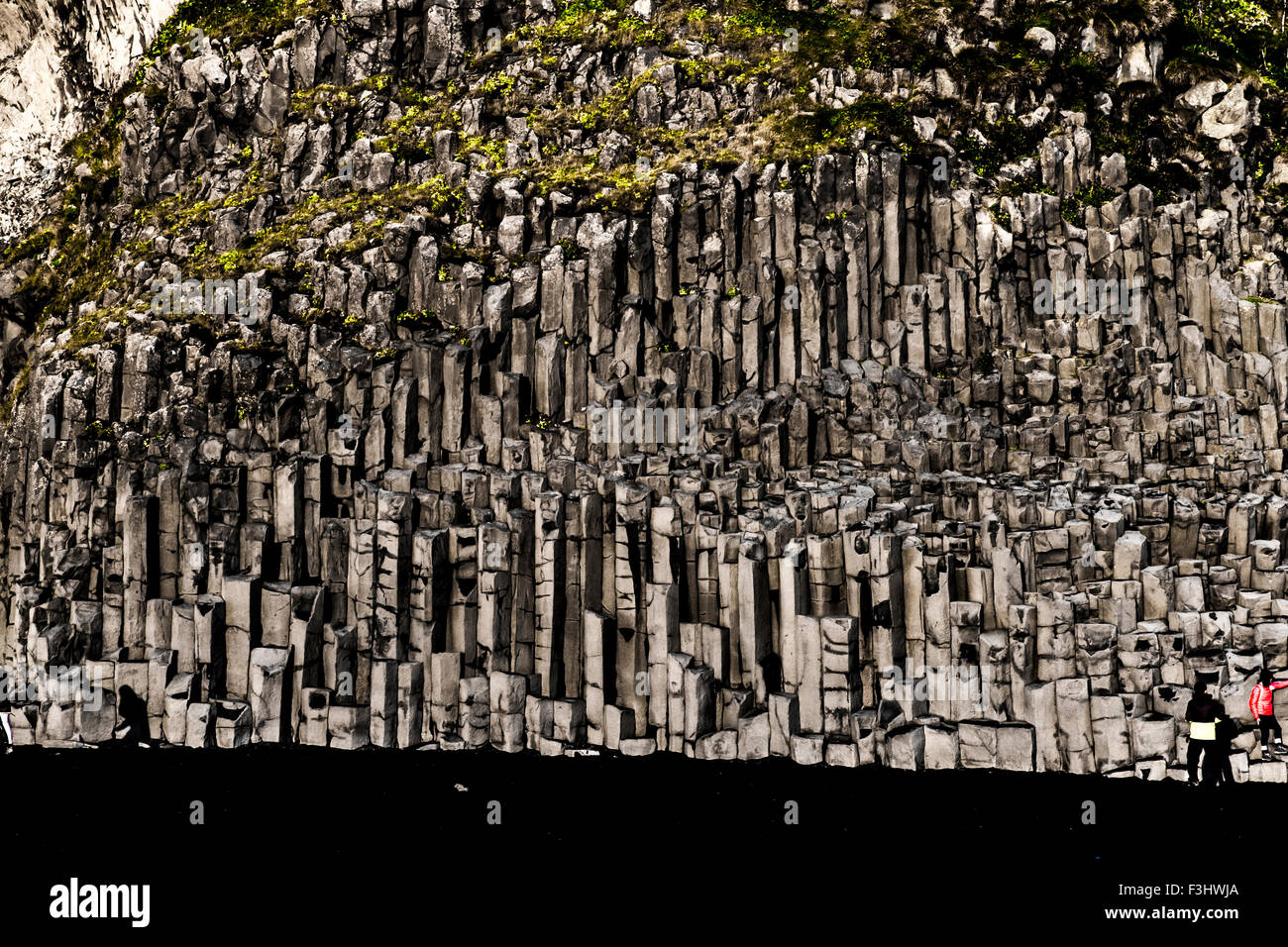 Basalt geometrical column rock formations on the black sand volcanic Kirkjufjara beach near Vik, Iceland Stock Photo