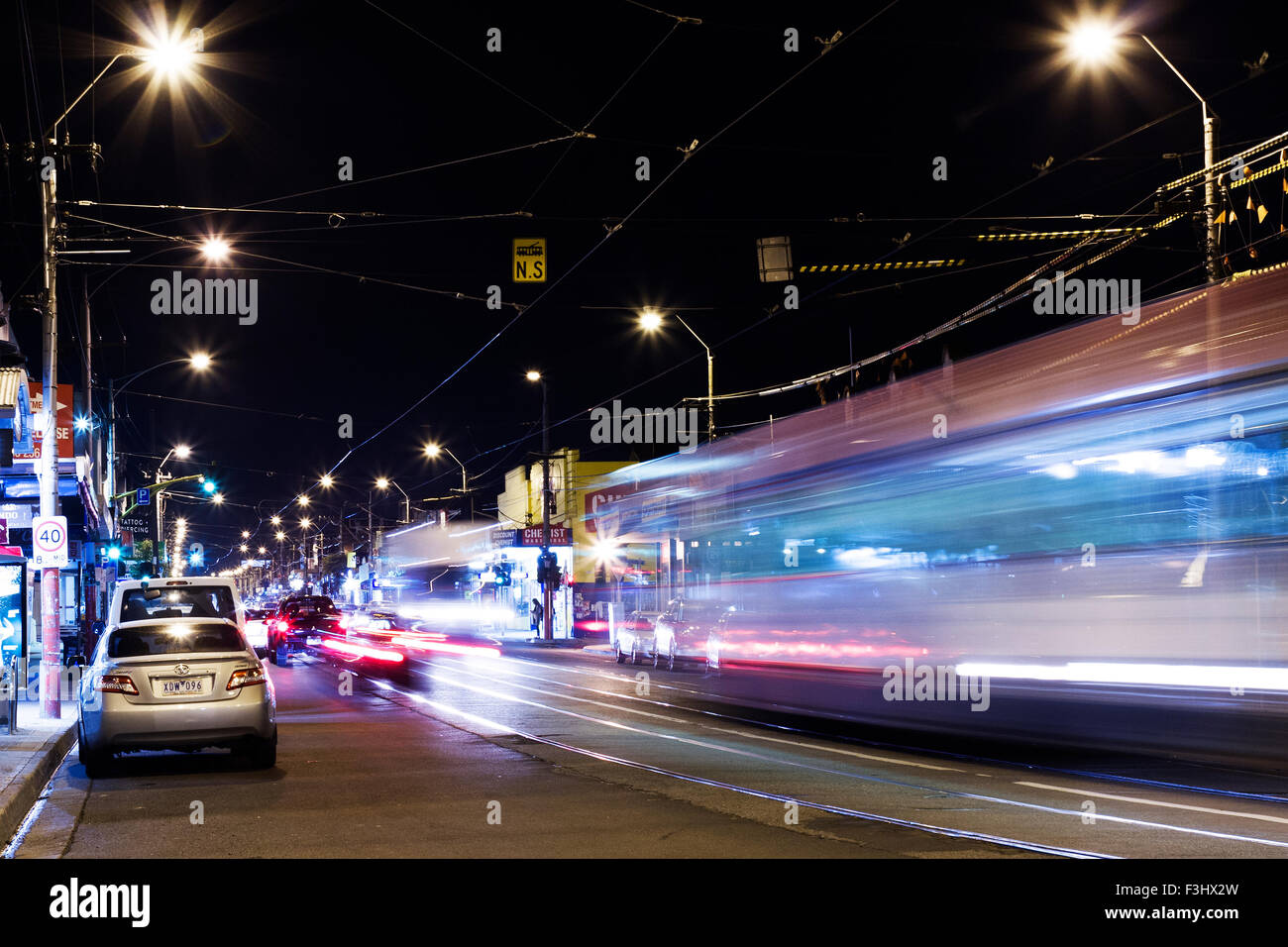 Night Traffic and trams on the northern end of High Street, Northcote, Melbourne, Australia Stock Photo