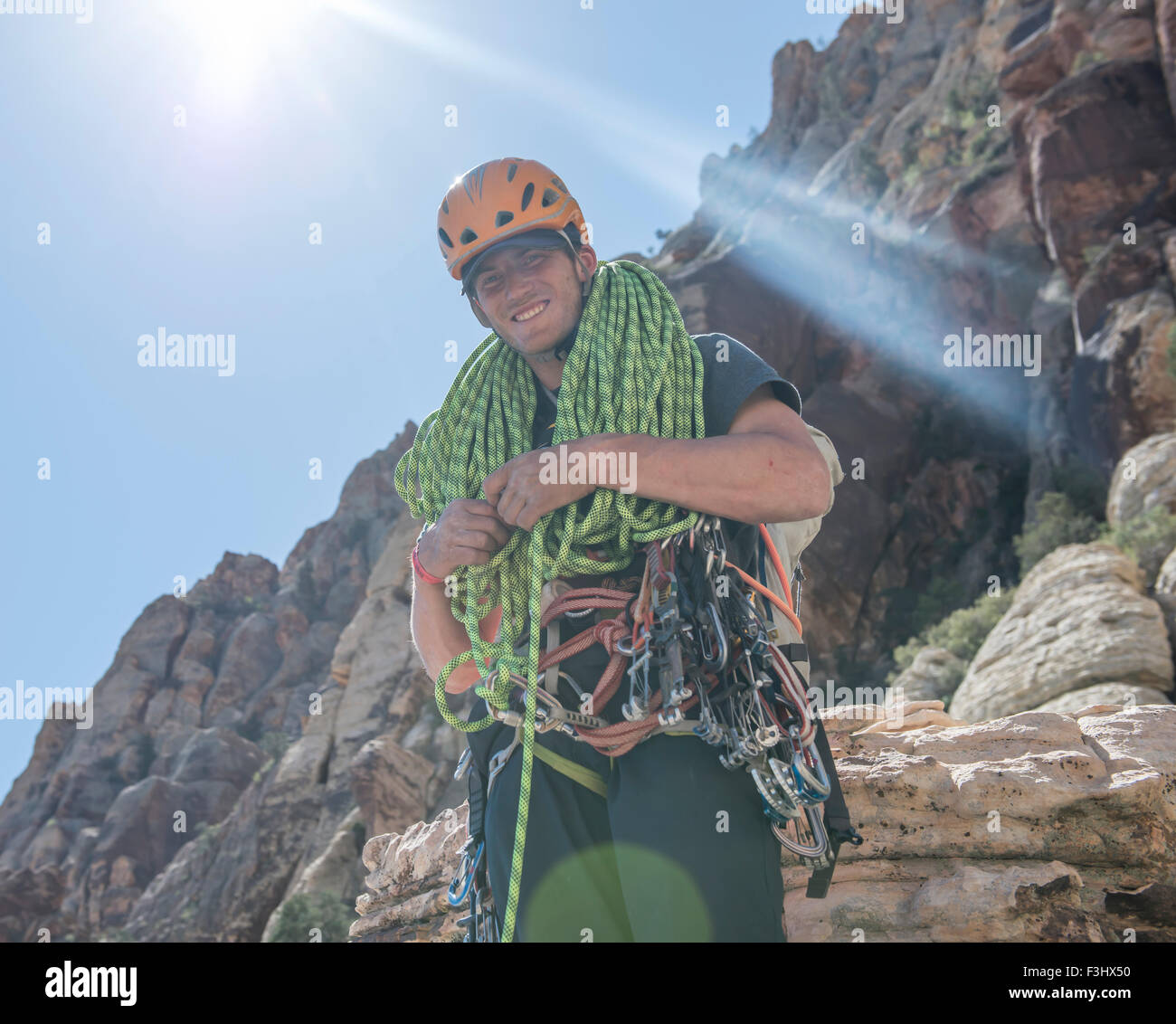 Climber coils a rope at the top of a climb in Red Rocks, Nevada. Stock Photo