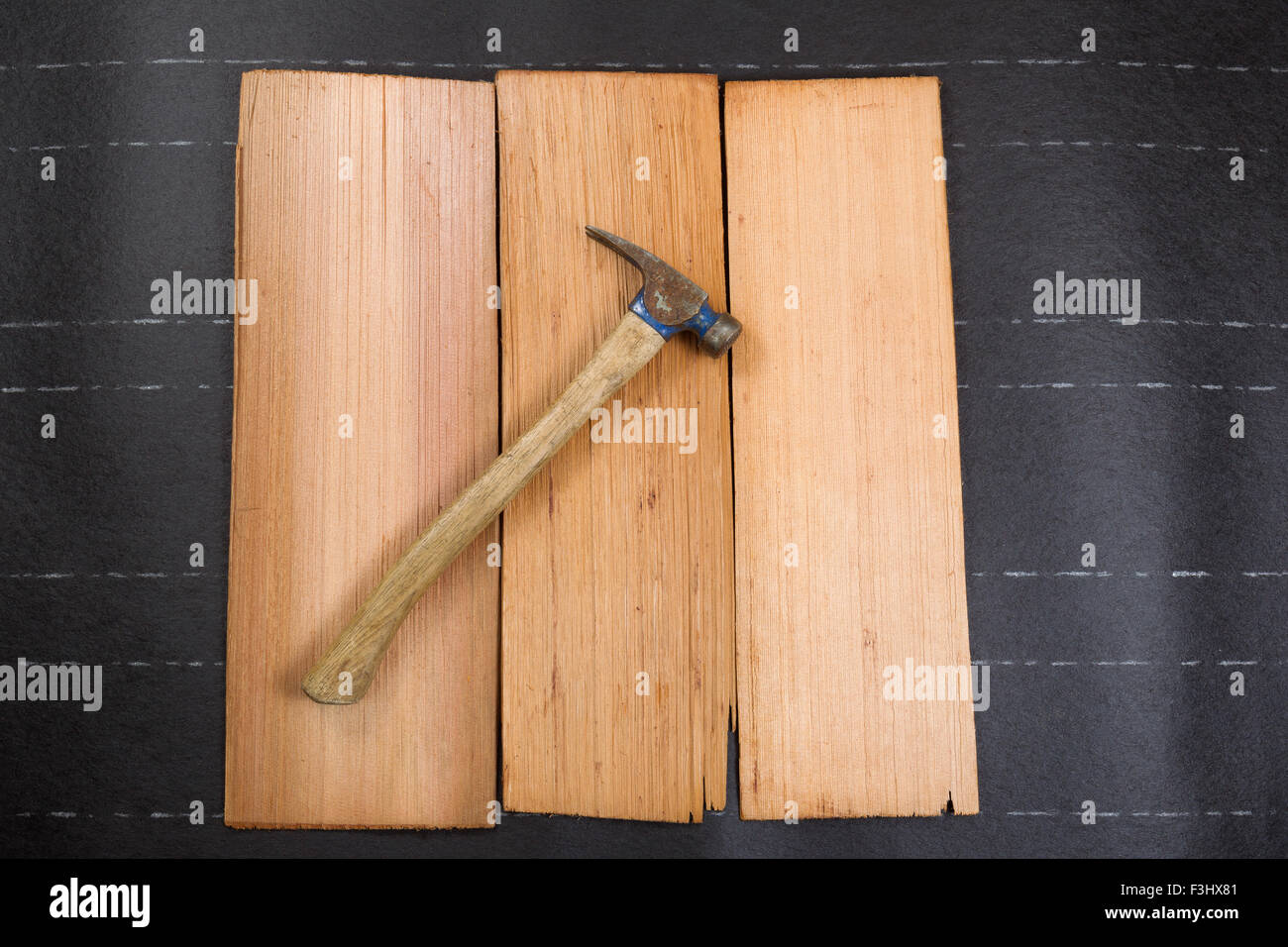 Used roofing hammer on new cedar shake shingles and felt paper in horizontal format. Stock Photo