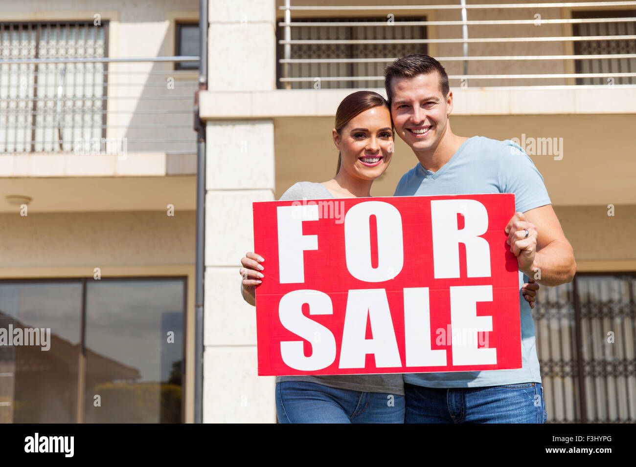 beautiful married couple outside home holding for sale sign Stock Photo ...