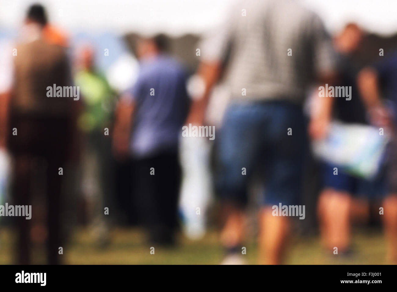 Blurred crowd of people outdoors, general public gathering concept with unrecognizable men and women out of focus, vintage tone Stock Photo