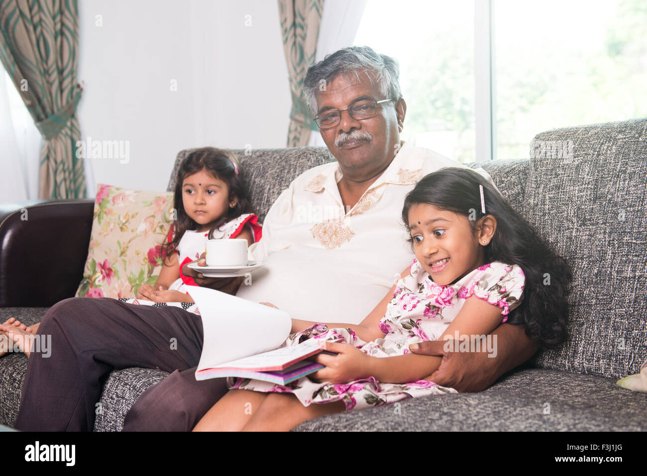 indian grandfather learning with his granddaughters Stock Photo