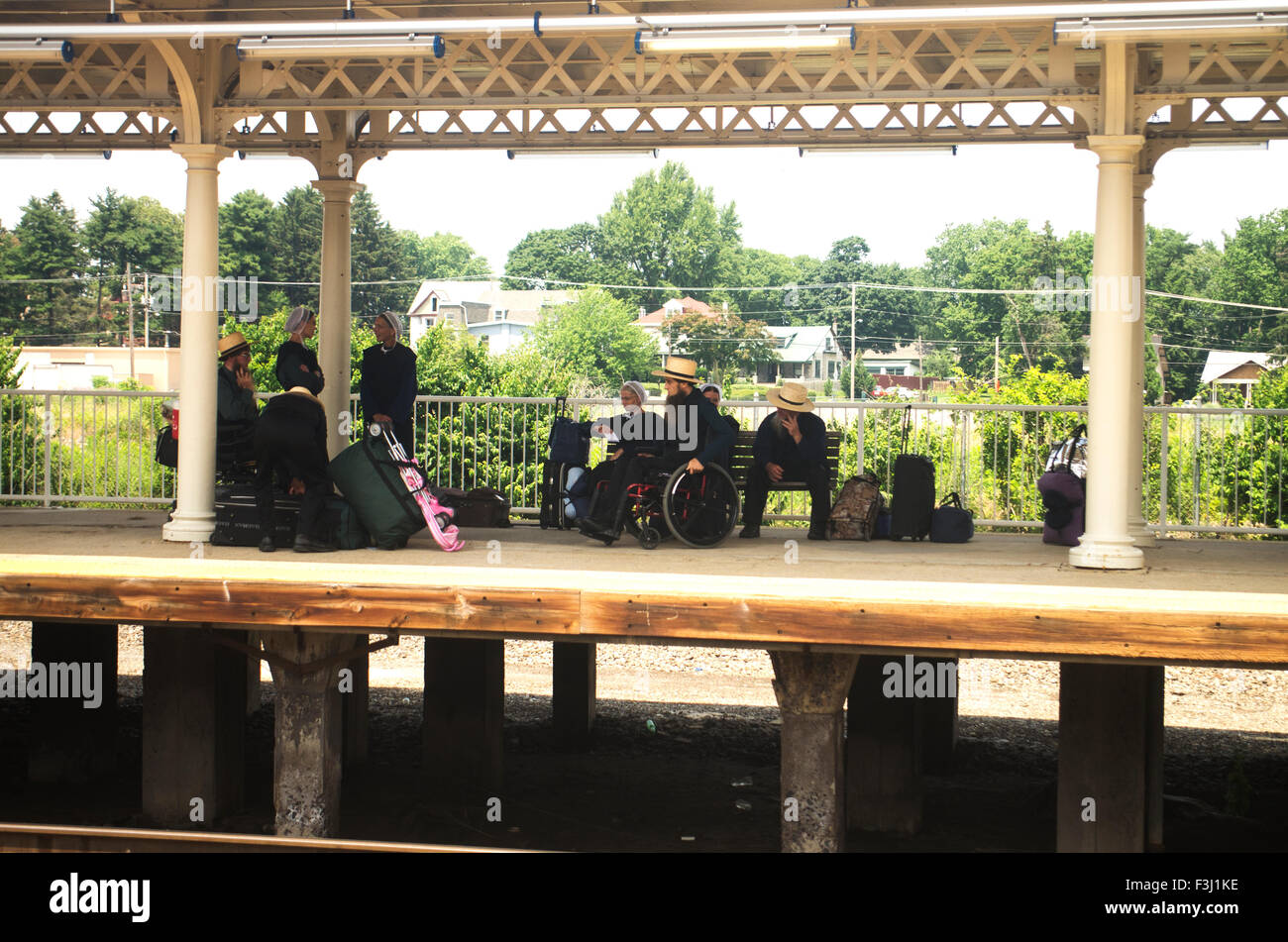 Pennsylvania Dutch group on a train platform near Pittsburgh, PA, one in a wheelchair Stock Photo