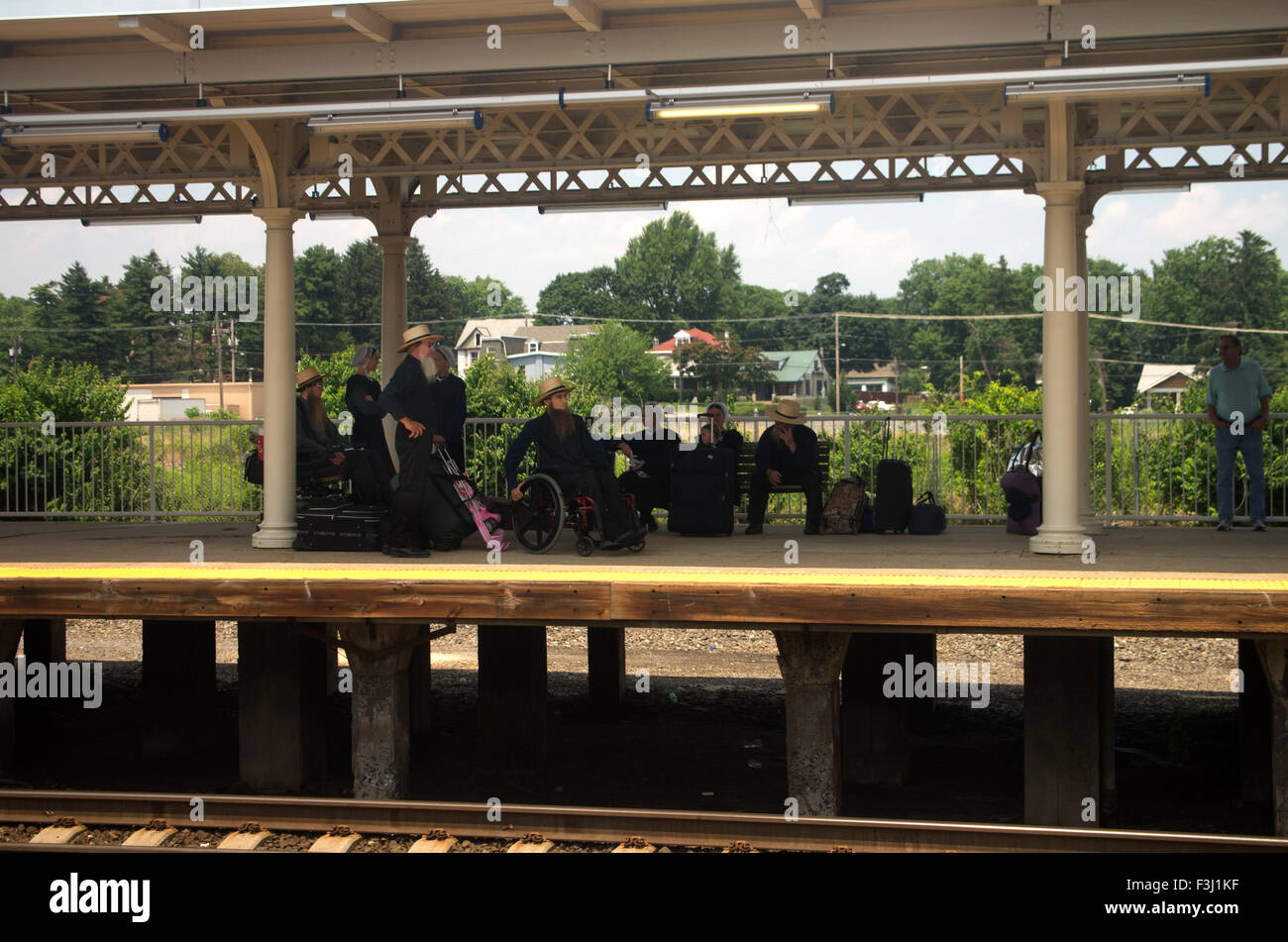 Pennsylvania Dutch group on a train platform near Pittsburgh, PA, one in a wheelchair Stock Photo