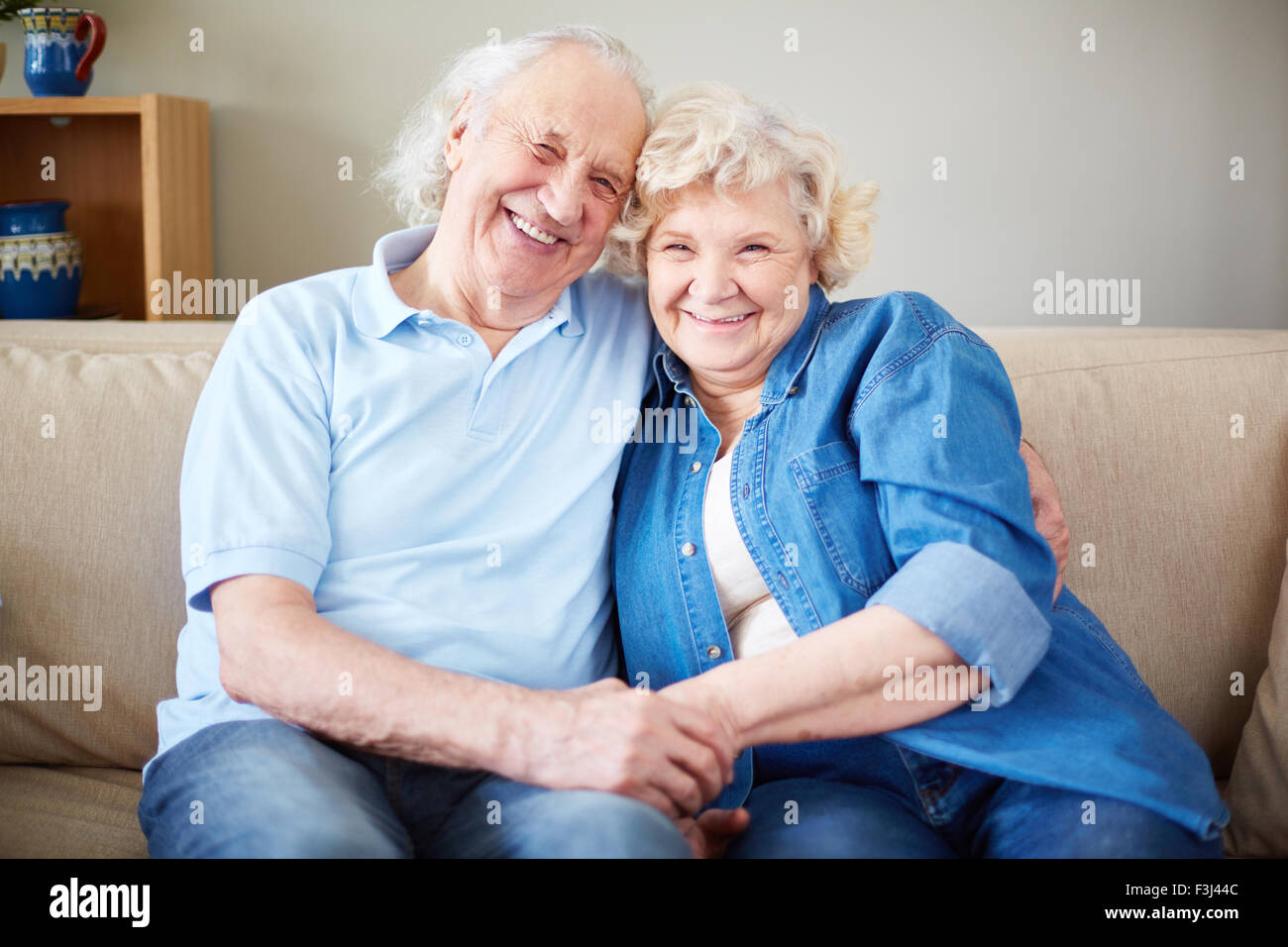 Amorous couple sitting on sofa hi-res stock photography and images - Alamy