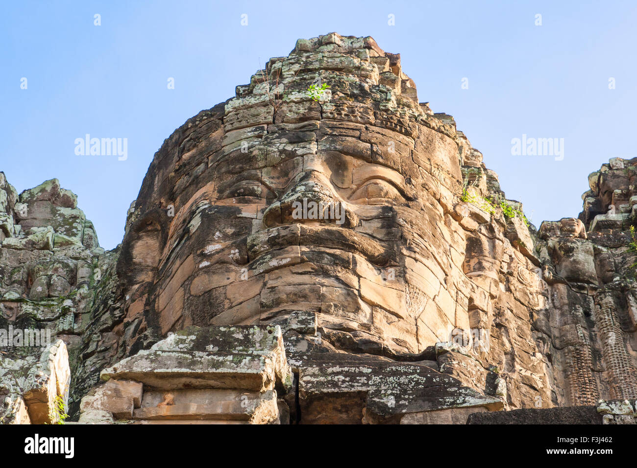 One of the giant stone faces at Bayon Temple at Angkor Wat, Cambodia Stock Photo