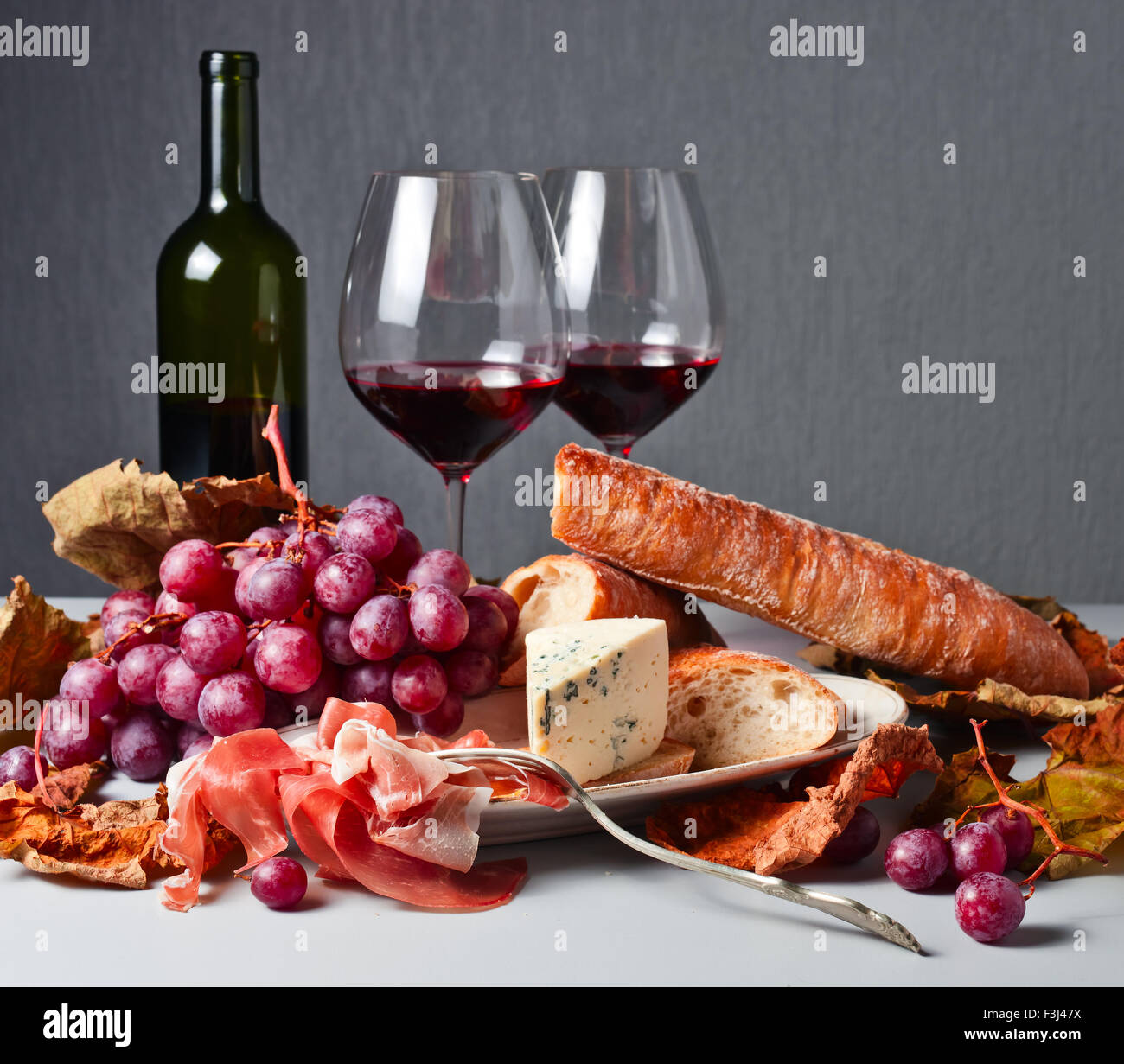 grapes , bread and snacks to red wine Stock Photo - Alamy