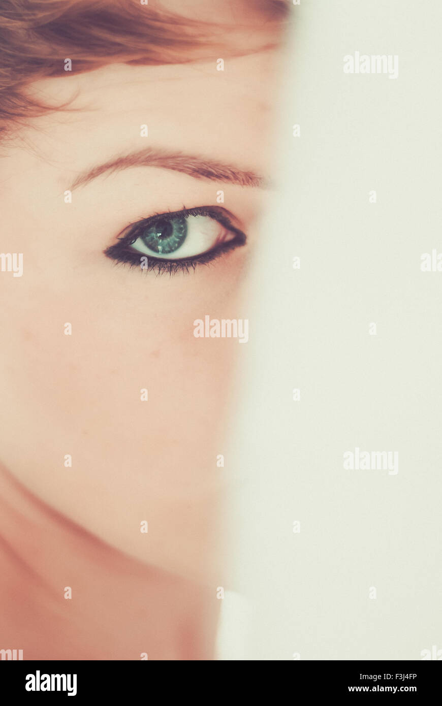 Young teenage girl with a blue eye looking past Stock Photo