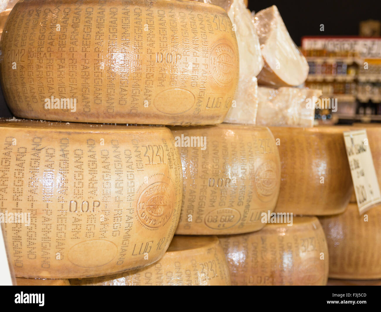stacked circular blocks of Parmigiano Reggiano Italian cheese for sale