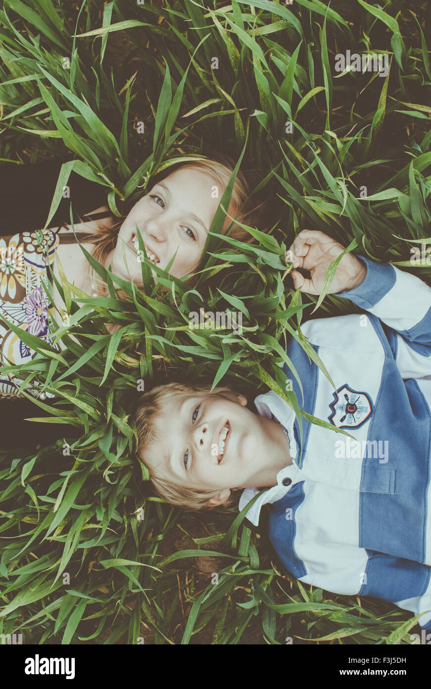 Two young children playing in a field Stock Photo