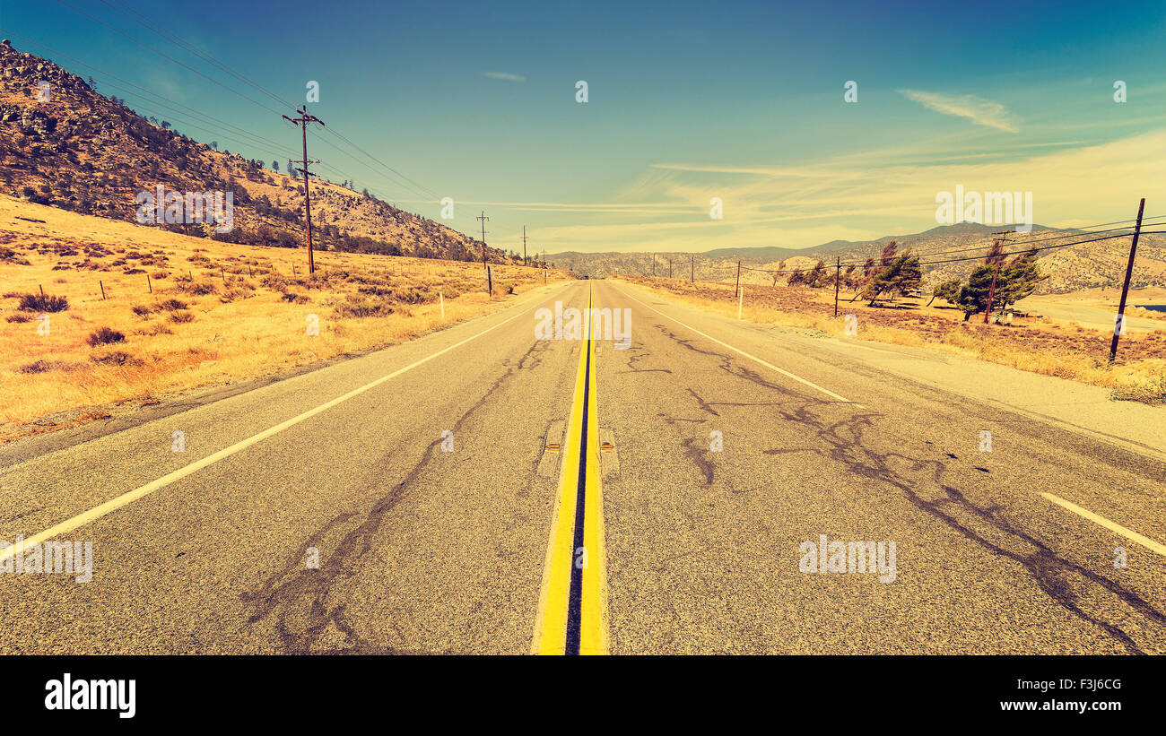 Retro old film style country highway in USA, travel adventure concept. Stock Photo