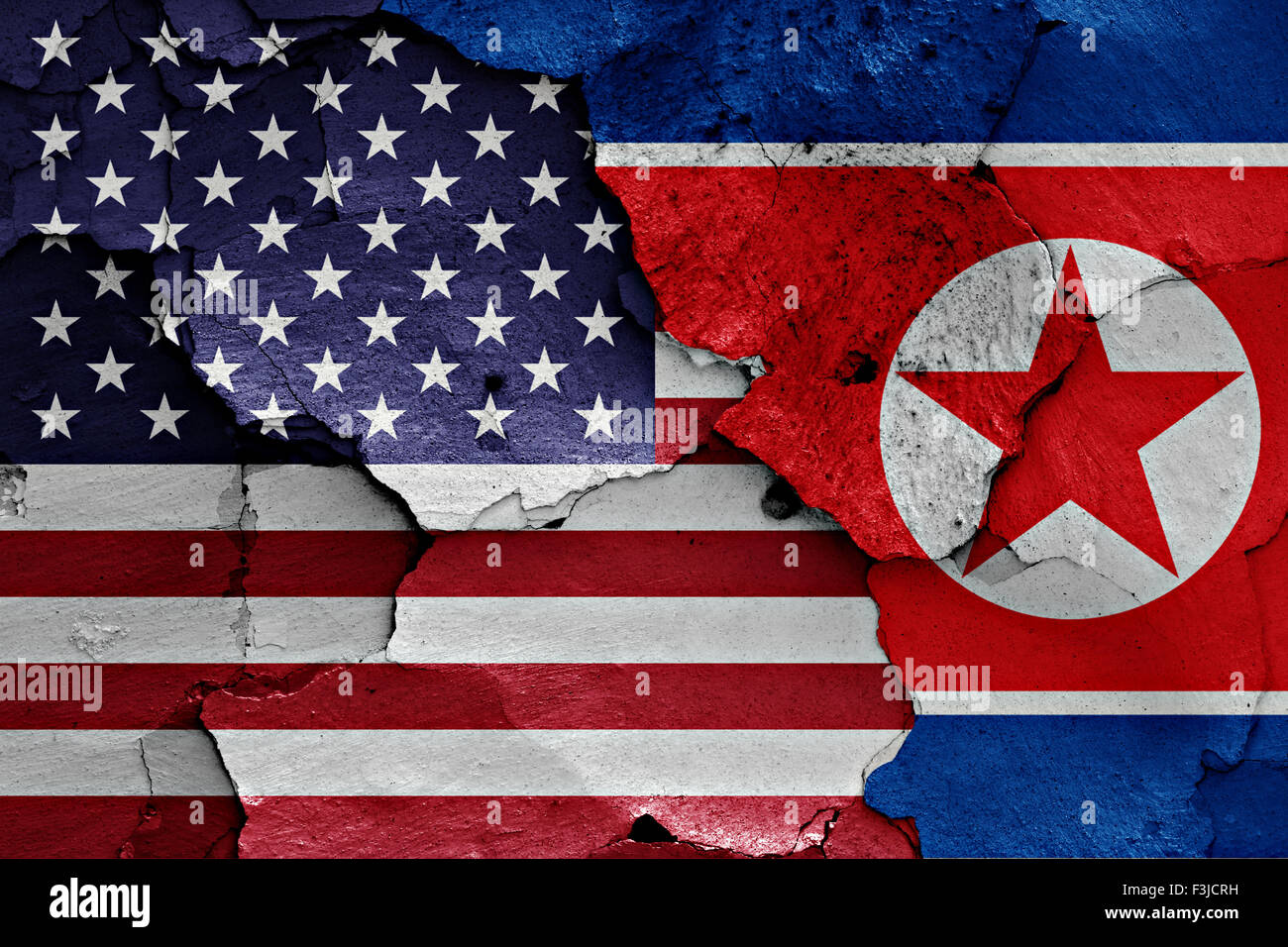 flags of United States and North Korea painted on cracked wall Stock Photo