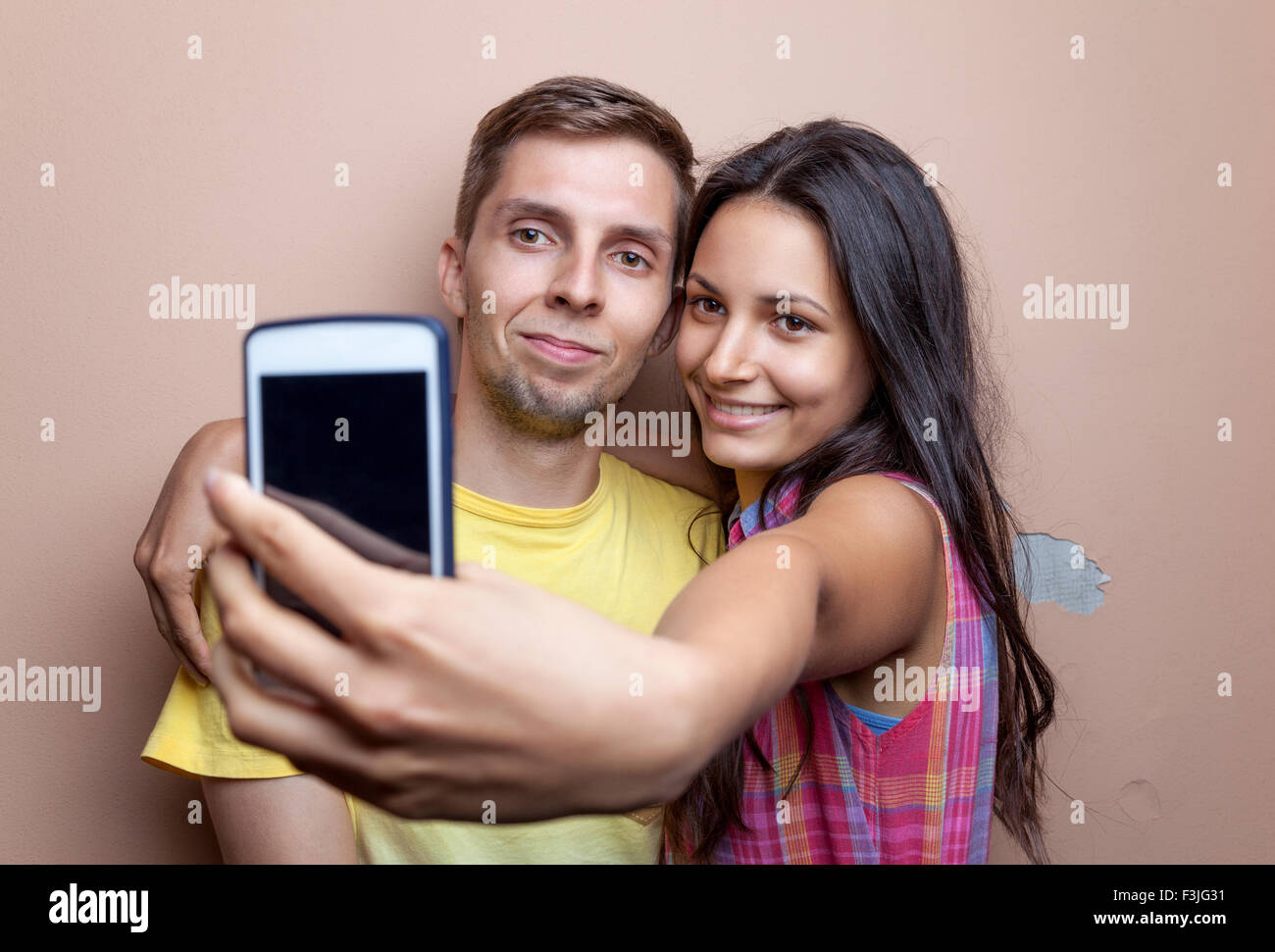 Young happy couple taking a selfie with mobile phone Stock Photo - Alamy